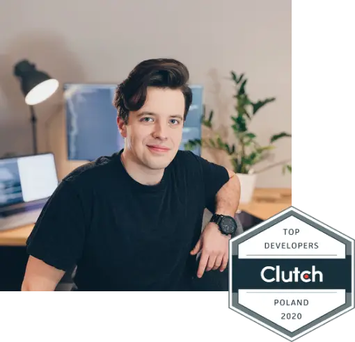 Wojciech Kałużny sitting in front of his desk with Clutch Top Developer in Poland badge